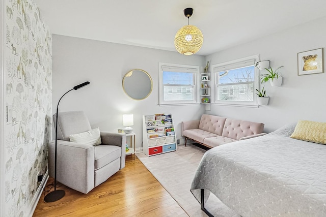 bedroom with wood finished floors and baseboards