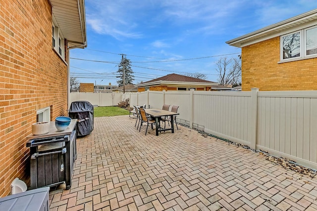 view of patio featuring outdoor dining area and a fenced backyard
