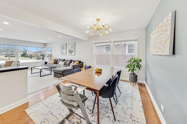 dining space with light wood-style floors, recessed lighting, a chandelier, and baseboards