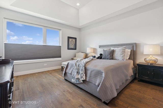 bedroom with dark wood-style floors and baseboards