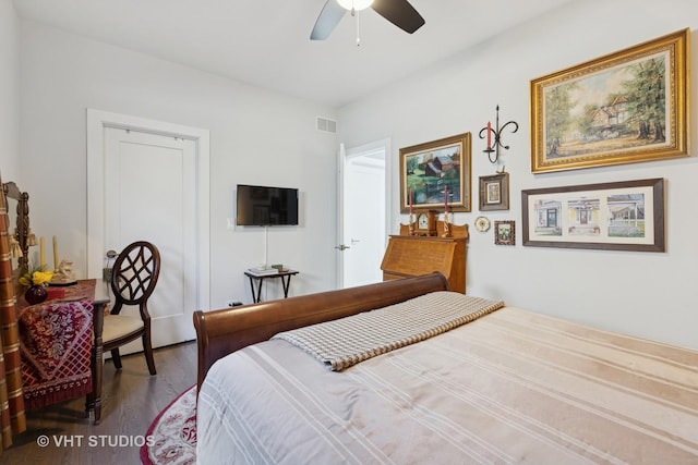 bedroom featuring ceiling fan, visible vents, and wood finished floors