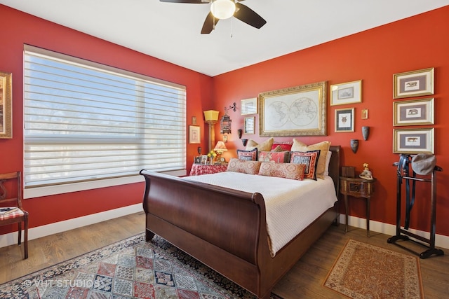 bedroom featuring wood finished floors, baseboards, and ceiling fan