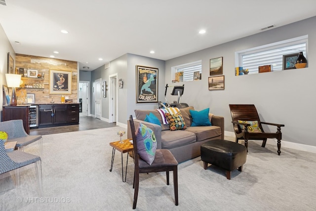 living area with recessed lighting, wet bar, and carpet flooring