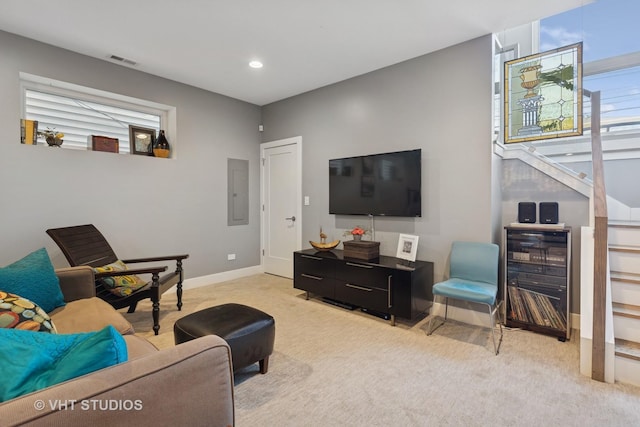 living area with visible vents, baseboards, electric panel, recessed lighting, and light colored carpet