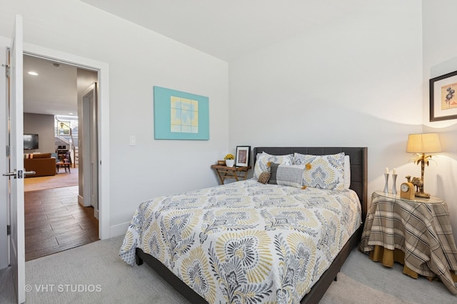 carpeted bedroom featuring baseboards