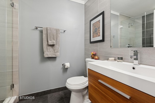 full bath with tile patterned floors, toilet, tile walls, and a stall shower