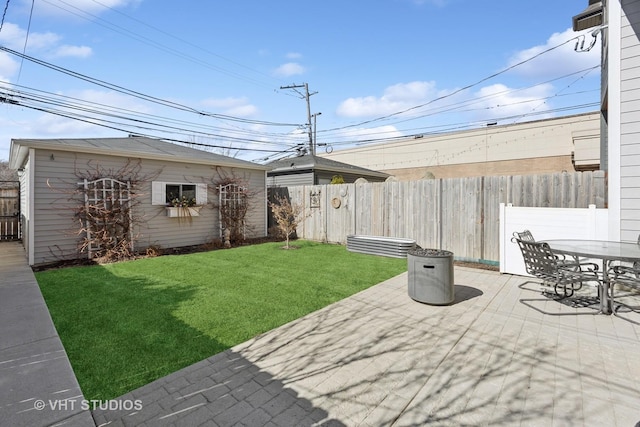 view of patio / terrace with an outbuilding, outdoor dining area, and a fenced backyard