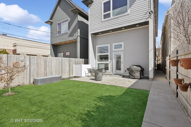 back of property featuring a lawn, a fenced backyard, and a patio area