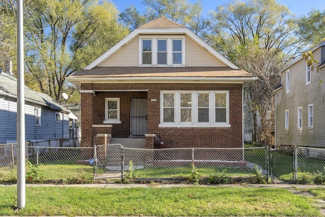 bungalow with a gate, a front lawn, and brick siding