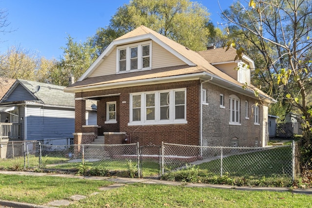 bungalow-style home with brick siding, a fenced front yard, a front lawn, and a gate