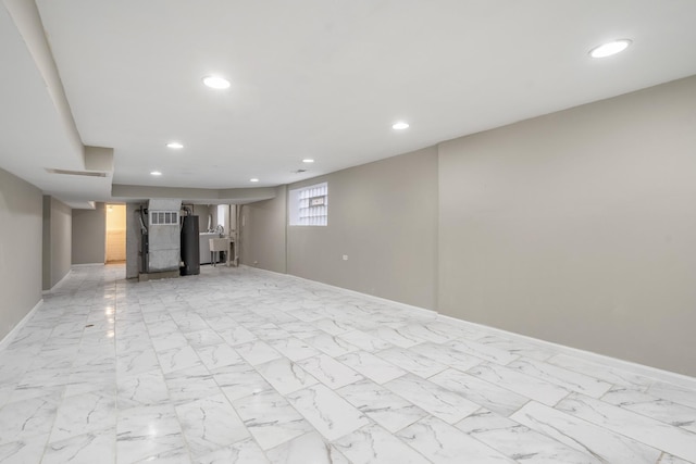 basement featuring marble finish floor, recessed lighting, and baseboards