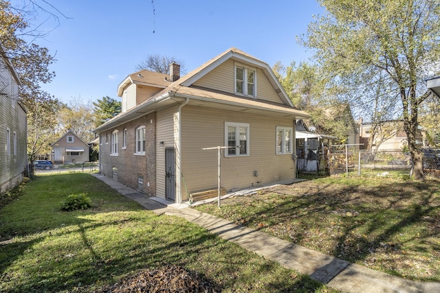 view of home's exterior with a lawn, a chimney, and fence