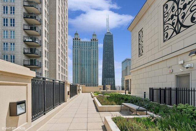 exterior space featuring fence and a city view