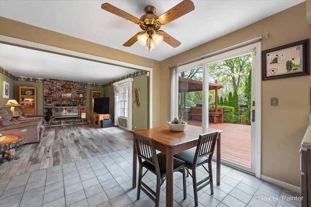 631 Alice Ct, Elgin, IL 60123 - dining area with healthy amount of natural light, ceiling fan, a fireplace, and baseboards