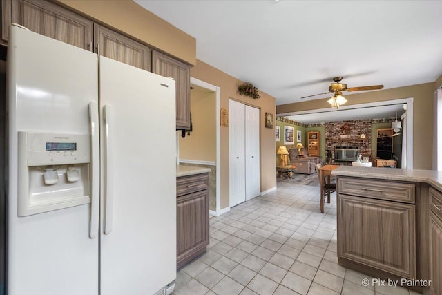 631 Alice Ct, Elgin, IL 60123 - kitchen featuring white refrigerator with ice dispenser, ceiling fan, light countertops, light tile patterned floors, and baseboards