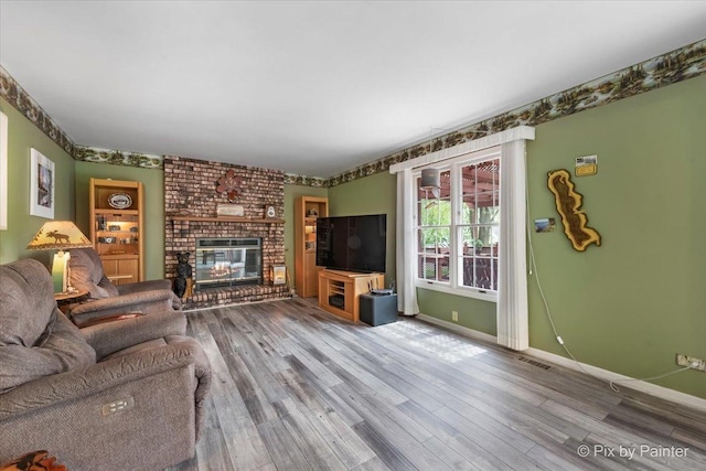 631 Alice Ct, Elgin, IL 60123 - living area featuring baseboards, wood finished floors, and a fireplace