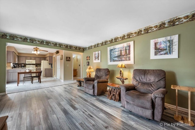 631 Alice Ct, Elgin, IL 60123 - sitting room with light wood finished floors, baseboards, and a ceiling fan
