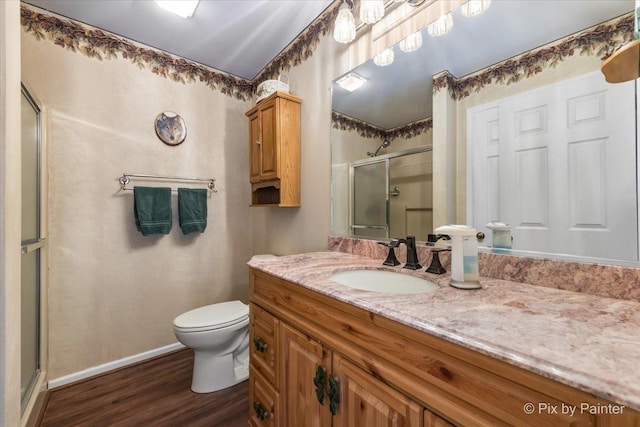 631 Alice Ct, Elgin, IL 60123 - bathroom featuring a stall shower, wood finished floors, toilet, baseboards, and vanity