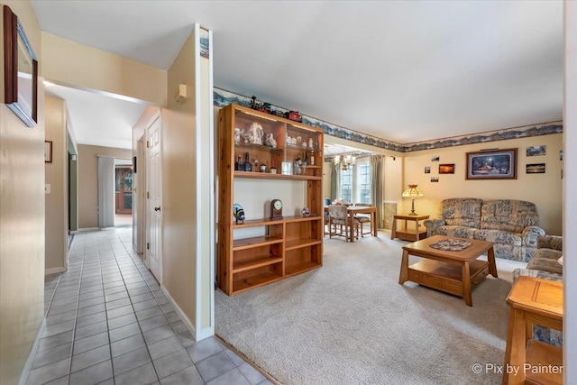 631 Alice Ct, Elgin, IL 60123 - living room featuring a chandelier, light tile patterned flooring, light colored carpet, and baseboards