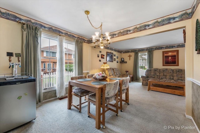 631 Alice Ct, Elgin, IL 60123 - carpeted dining room featuring a chandelier and healthy amount of natural light