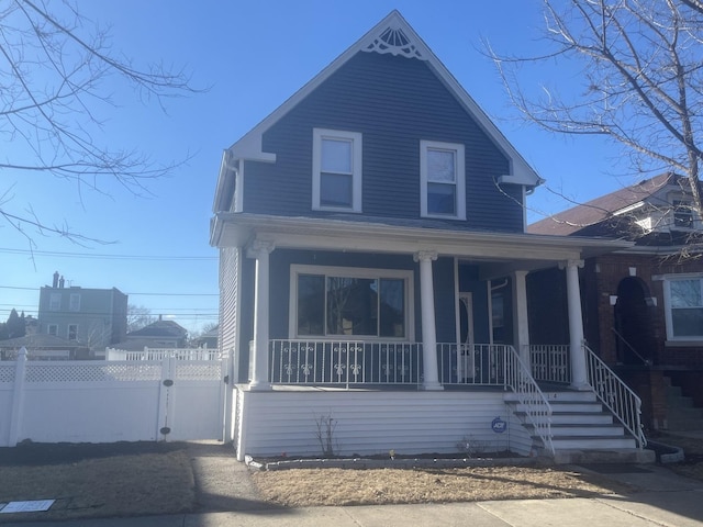 view of front of home with covered porch and fence