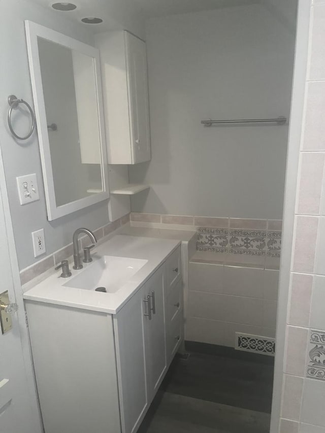 bathroom featuring tile walls and vanity