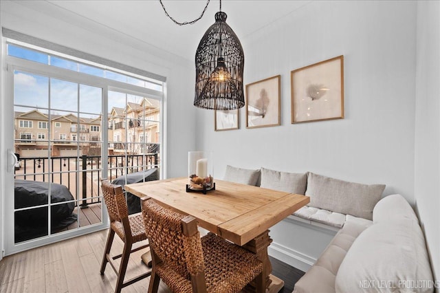 dining space with breakfast area, wood-type flooring, and a chandelier