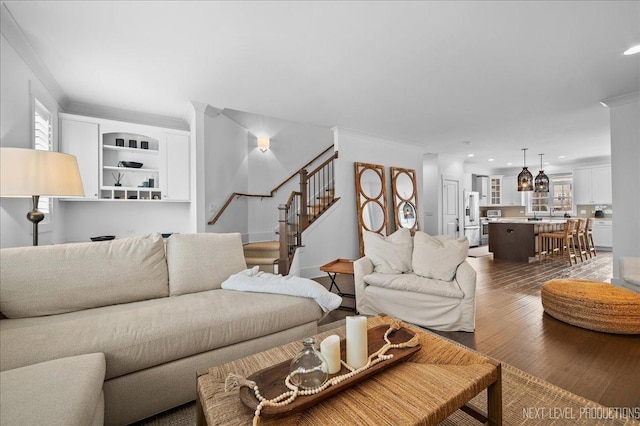 living room featuring ornamental molding, recessed lighting, dark wood-style flooring, and stairs