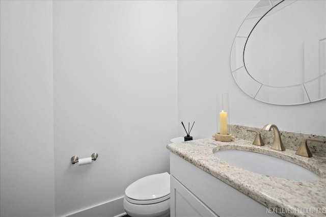 bathroom with toilet and vanity