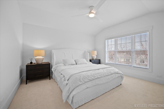 bedroom with lofted ceiling, baseboards, a ceiling fan, and light colored carpet