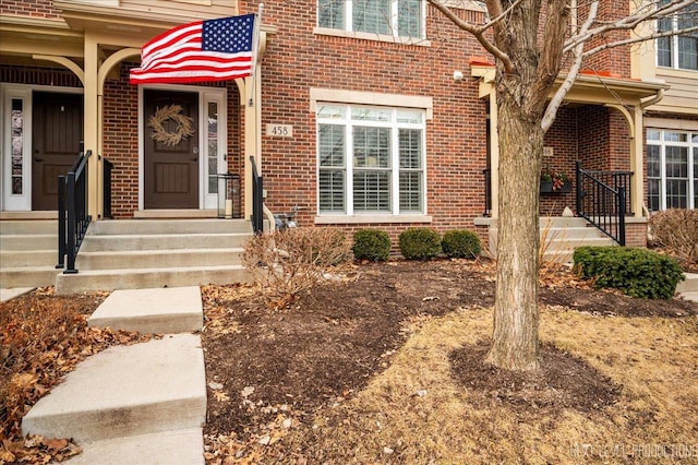 property entrance featuring brick siding