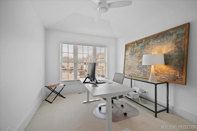 home office featuring vaulted ceiling, carpet flooring, a ceiling fan, and baseboards