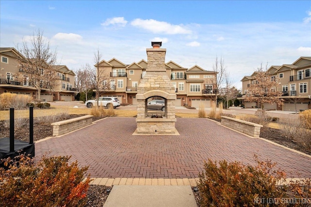 view of community featuring driveway, a patio area, and a residential view