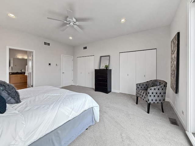 bedroom with multiple closets, recessed lighting, visible vents, and carpet floors