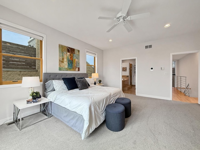 bedroom with carpet, multiple windows, visible vents, and baseboards