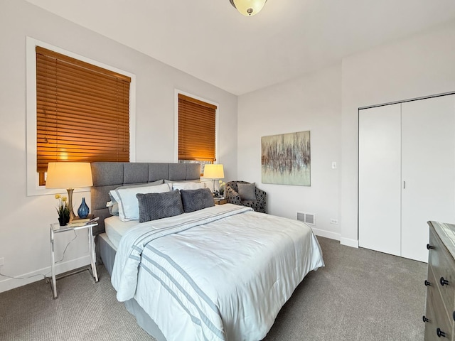 bedroom with carpet, a closet, visible vents, and baseboards