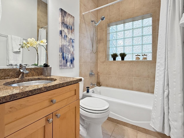 bathroom with tile patterned flooring, shower / tub combo with curtain, vanity, and toilet