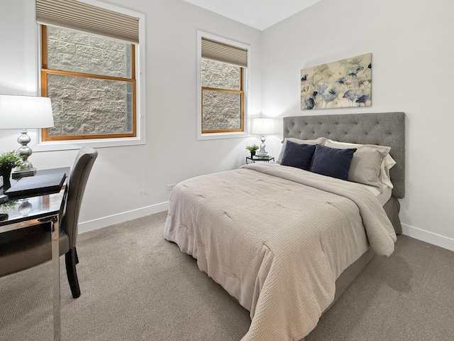 bedroom with carpet flooring and baseboards