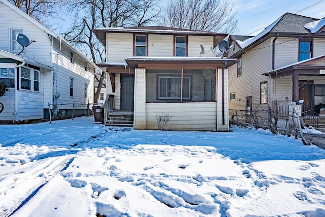 view of front of house with a sunroom and fence