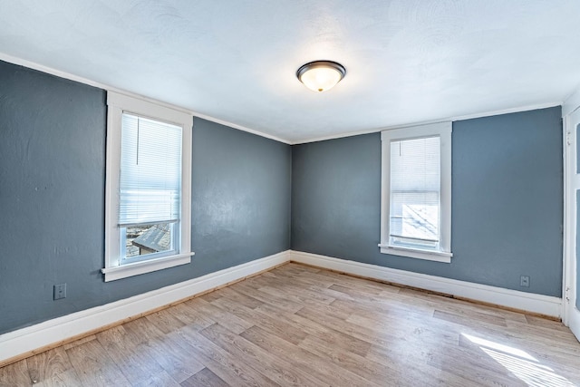 empty room featuring light wood-style floors and baseboards