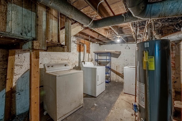 unfinished below grade area featuring water heater and washer and dryer