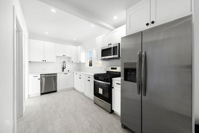 kitchen with marble finish floor, stainless steel appliances, light countertops, white cabinetry, and recessed lighting