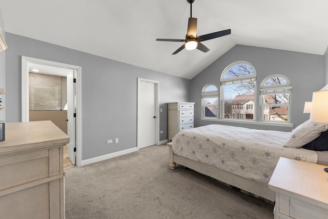 carpeted bedroom with baseboards, ensuite bath, ceiling fan, and vaulted ceiling