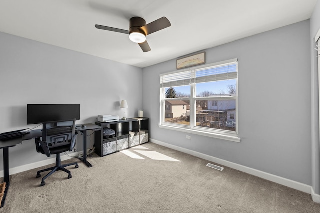 home office featuring carpet, baseboards, visible vents, and a ceiling fan