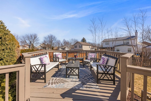 wooden deck featuring an outdoor living space and a residential view