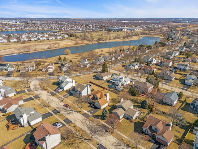 drone / aerial view with a residential view and a water view