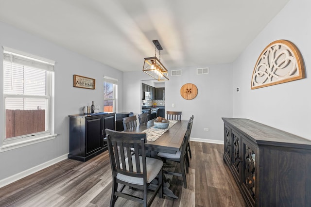 dining room featuring visible vents, baseboards, and dark wood-style flooring