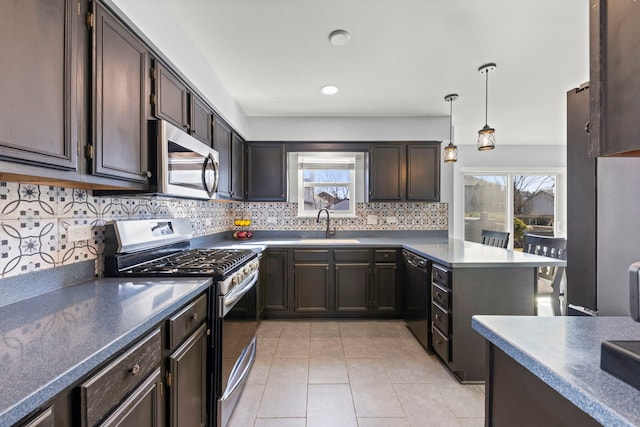 kitchen featuring a sink, stainless steel appliances, a healthy amount of sunlight, and decorative backsplash