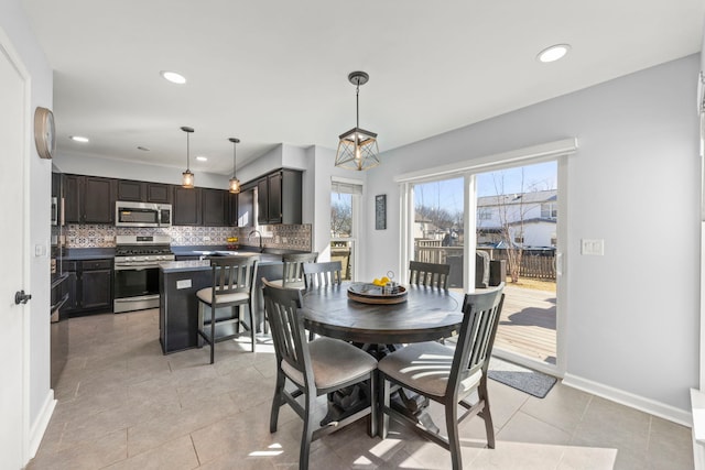 dining area with light tile patterned flooring, recessed lighting, and baseboards