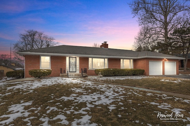 single story home featuring a garage, driveway, brick siding, and a chimney